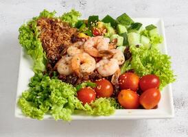 prawn poke bowl with tomato, cucumber and lettuce leaf served in dish isolated top view of singapore food photo