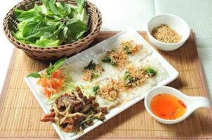 Shredded Beef Tenderloin with Lemongrass Marinara and chilli sauce served in dish isolated of table top view fast food snacks photo