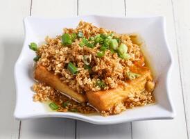 chaipoh tofu topping with spring onion served in dish isolated on table top view of singapore food photo