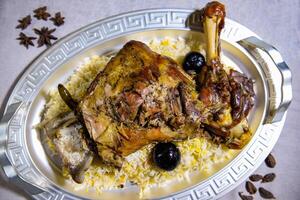 Laham mandi mutton shoulder biryani pulao rice mandy basmati served in dish isolated on food table top view of middle east spices photo