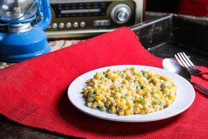 Corn Salad with cream served in dish isolated on red mat top view on table arabic food photo