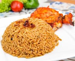 Chicken Bukhari mandi biryani rce pilaf with fried onion served in dish isolated on table top view of arabic food photo