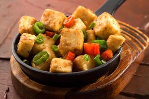 Mapo Tofu with spring onion and red pepper served in dish isolated on background side view of chinese food photo