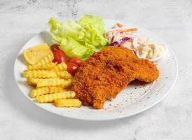 Crispy fish and chips with lime and salad served in dish isolated top view of singapore food photo