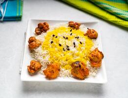 chicken tikka biryani rice served in dish isolated on table top view of arabic food photo