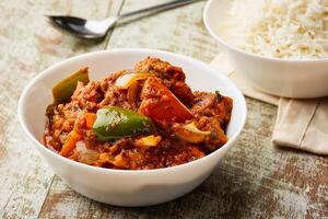 Tandoori chicken Masala korma karahi with boiled rice served in dish isolated on table top view of arabic food photo