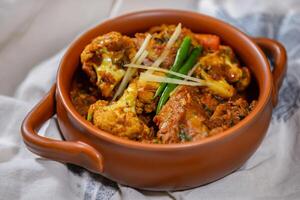 Aoo gobi chicken or potato, cauliflower, chicken served in dish isolated on food table top view of middle east spices photo