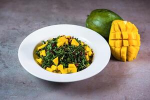 Kale mango served in dish isolated on grey background top view of bahrain food photo