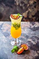 Passion Fruit Mojito Soda with mint served in cocktail glass isolated on dark background side view of healthy drink photo