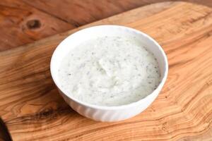 Spinach Yugurt raita served in dish isolated on wooden table top view middle eastern appetizers food photo