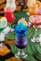 Blue Hawaiian lagoon ice drink with lime slice served in glass isolated on table side view of healthy morning arabic drink photo