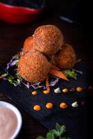 Mushroom Balls with mayonnaise dip served in dish isolated on wooden table side view of arabic food photo