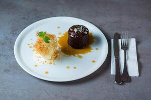 Sticky Toffee Dates Pudding served in dish isolated on grey background top view of bahrain food photo