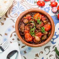 Dum Pukht or Meat Mahmasa with tomato, onion served in dish isolated on table top view of arabic food photo