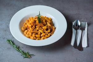 Sausage Pasta served in dish isolated on grey background top view of bahrain food photo
