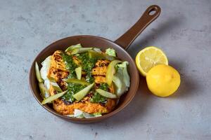 Sizzling Halloumi Cheese with lemon served in dish isolated on grey background top view of bahrain food photo