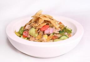 FATTOUSH salad with cucumber, crackers, onion, tomato and lemon served in dish isolated on background side view of arab food photo