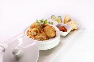 Spicy Mutton Biryani with fried onion, coriander, cashew nut and raita served in dish isolated on background side view of arab food photo