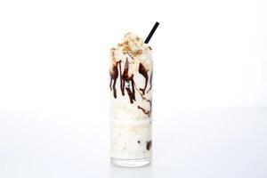 Lotus milkshake and straw served in glass isolated on grey background side view of healthy morning arabic drink photo