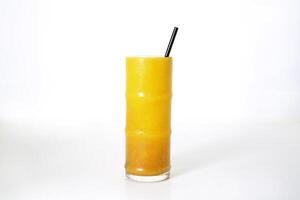 Mango passion fruit juice with straw served in glass isolated on grey background side view of healthy morning arabic drink photo