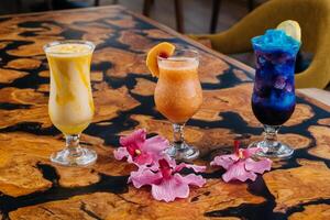 Assorted fruit juice of apple, strawberry, watermelon, passion fruit, mango, orange served in glass isolated on table side view of healthy morning arabic drink photo