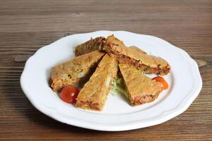 Egg omelette or omelet with cabbage and tomato served in dish isolated on table side view of arabic food photo