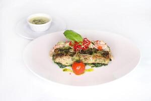 HERB CRUSTED HAMOUR FILLET with sauce served in dish isolated on table top view of arabic food photo