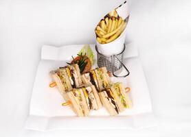 Club Sandwiches with french fries served in dish isolated on background side view of arab food photo