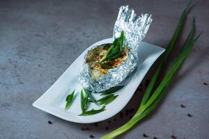 Jacket Potato with onion and mushroom served in dish isolated on grey background top view of bahrain food photo