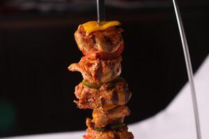 CHICKEN SHISH TAWOOK with onion, tomato, lemon and pita bread served in dish isolated on table side view of arabic bbq food photo