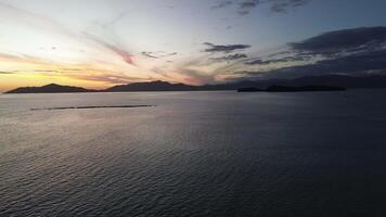 Aerial view of sunrise over the sea. flying over water into a beautiful sunrise video