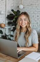 Woman Working on Laptop at Table photo