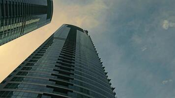 Modern Skyscraper Against Sky, Upward view of a modern skyscraper touching the sky. video