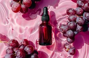Bottle of Liquid on Plate of Grapes photo