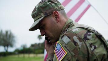 American Military Man Talks On The Phone With His Wife On The Base At War video