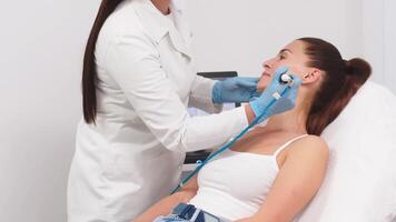 Caucasian woman receiving facial procedure of cleansing the skin. Portrait and natural woman face with healthy freckle skin texture. Aesthetic, facial and skincare cosmetology video