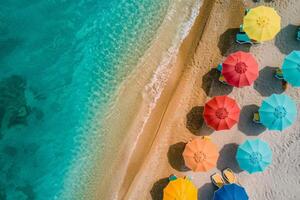 Top view of sea and colored sun umbrellas on sand beach photo