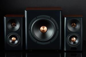 Sound audio system with two satellites and subwoofer on dark background. photo