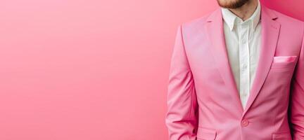 Man in Pink Business Suit Posing Against Pink Backdrop photo