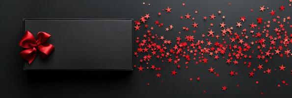 AI generated A beautiful small black box with a red bow lies on the left on a black minimalistic background photo