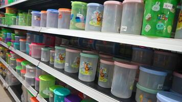 food storage containers and kitchen utensils on supermarket shelves for sale photo