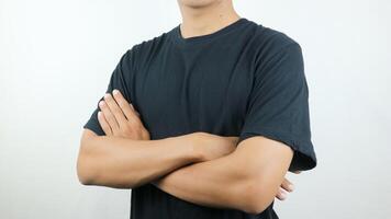 man athlete, bodybuilder in black t-shirt with arms crossed on the body on the white background photo