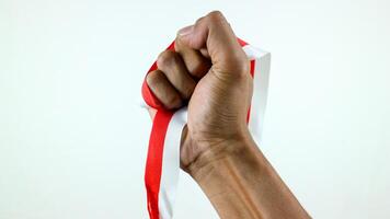 hand holding ribbon, red and white flag of Indonesia independence day August 17th, i love indonesia photo