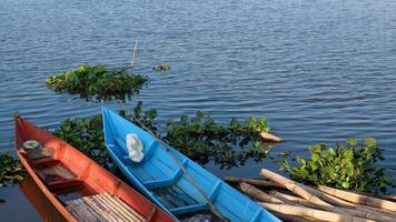 colorful fishing boat in a calm lake water. old wooden fishing boat in a still lake water photo