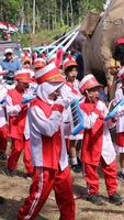 Drummers in red and white uniforms march in the Indonesian Independence Day parade photo