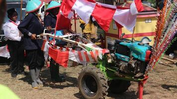 ambarawa, agosto 17 2023. indonesio agricultores vestir sombreros y traer banderas a el indonesio independencia día carnaval. foto