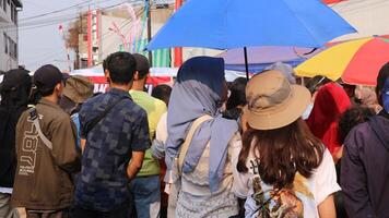 crowd of happy people participate in the carnival in the street block photo