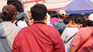 crowd of happy people participate in the carnival in the street block photo