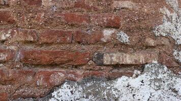 Old Brick Wall Texture Background with Peeling White Paint. photo