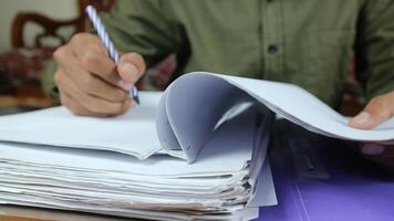 Businessman Preparing reports papers. Piles of unfinished document achieves with paper clip. photo